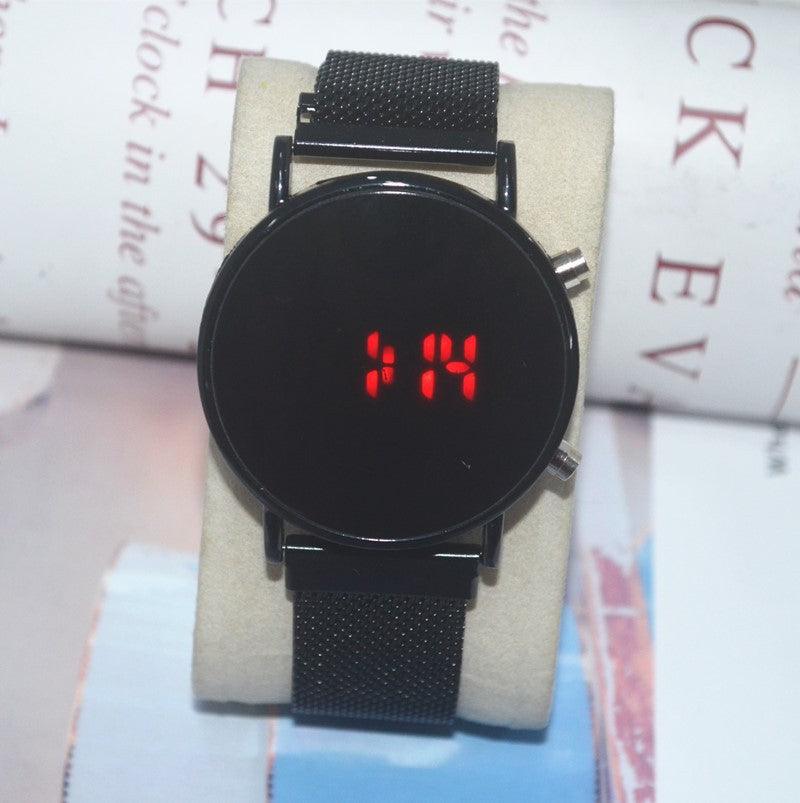 Black LED digital watch with red digits on a round black screen and black mesh strap