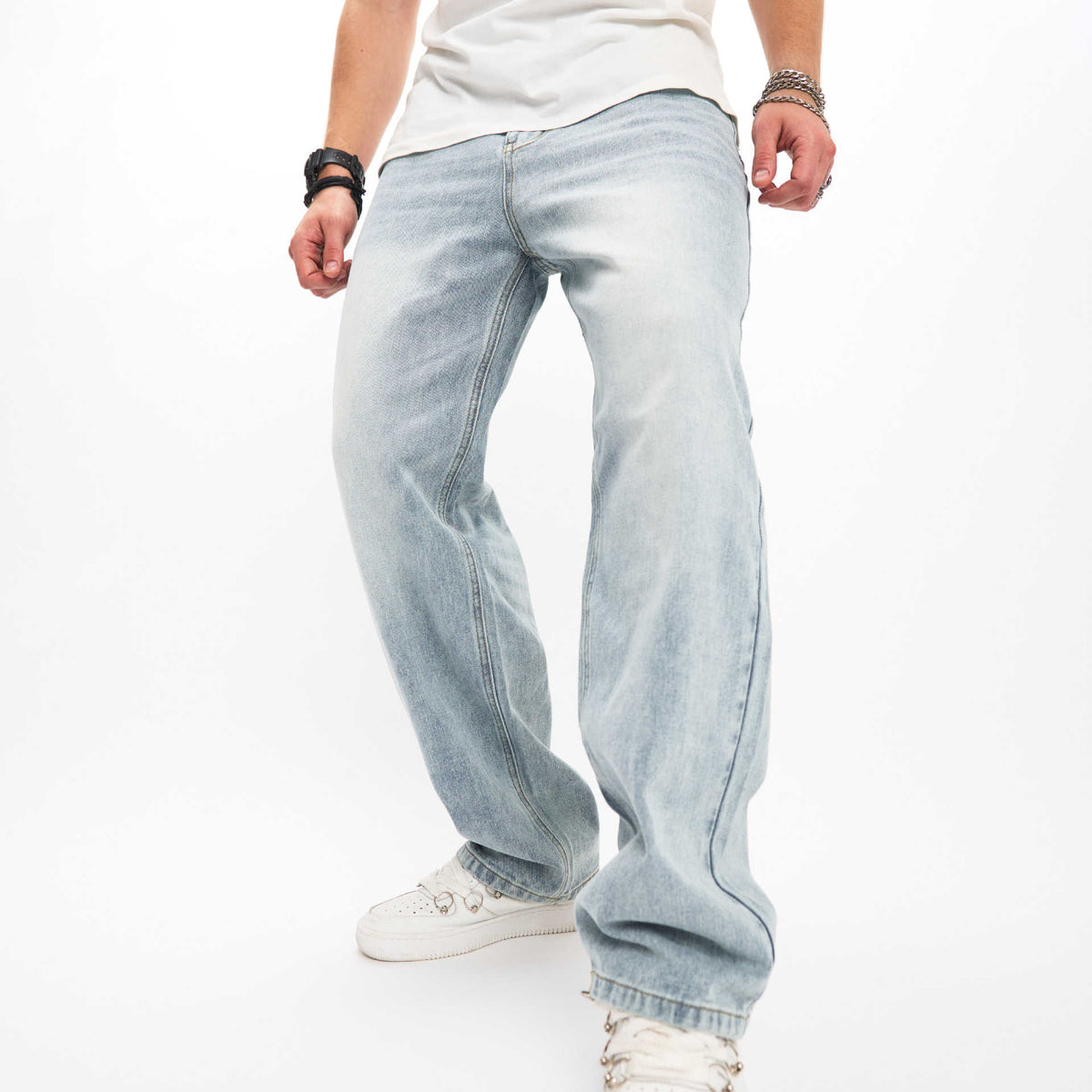 Light wash biker jeans with loose fit, whiskered wash, and cuffed ankles