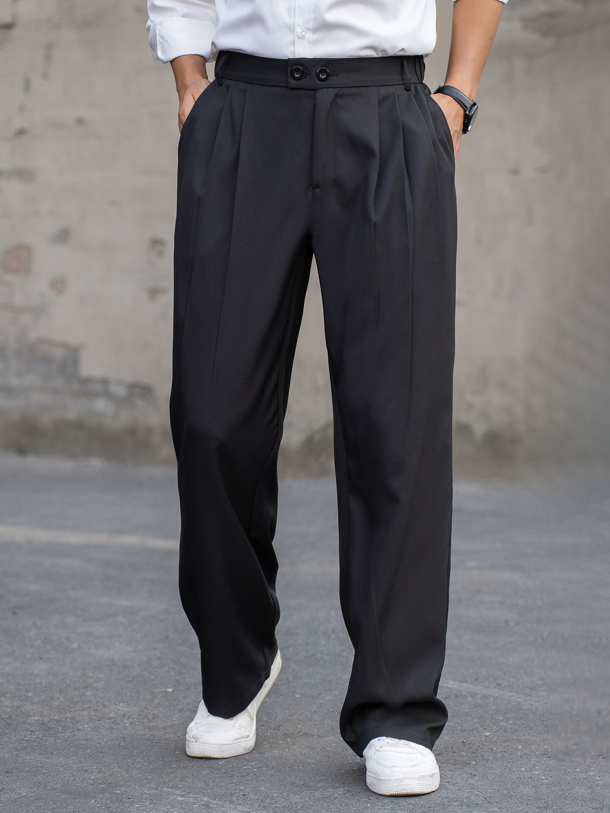 Men's black baggy casual pants with pleats, button waistband, and relaxed straight legs