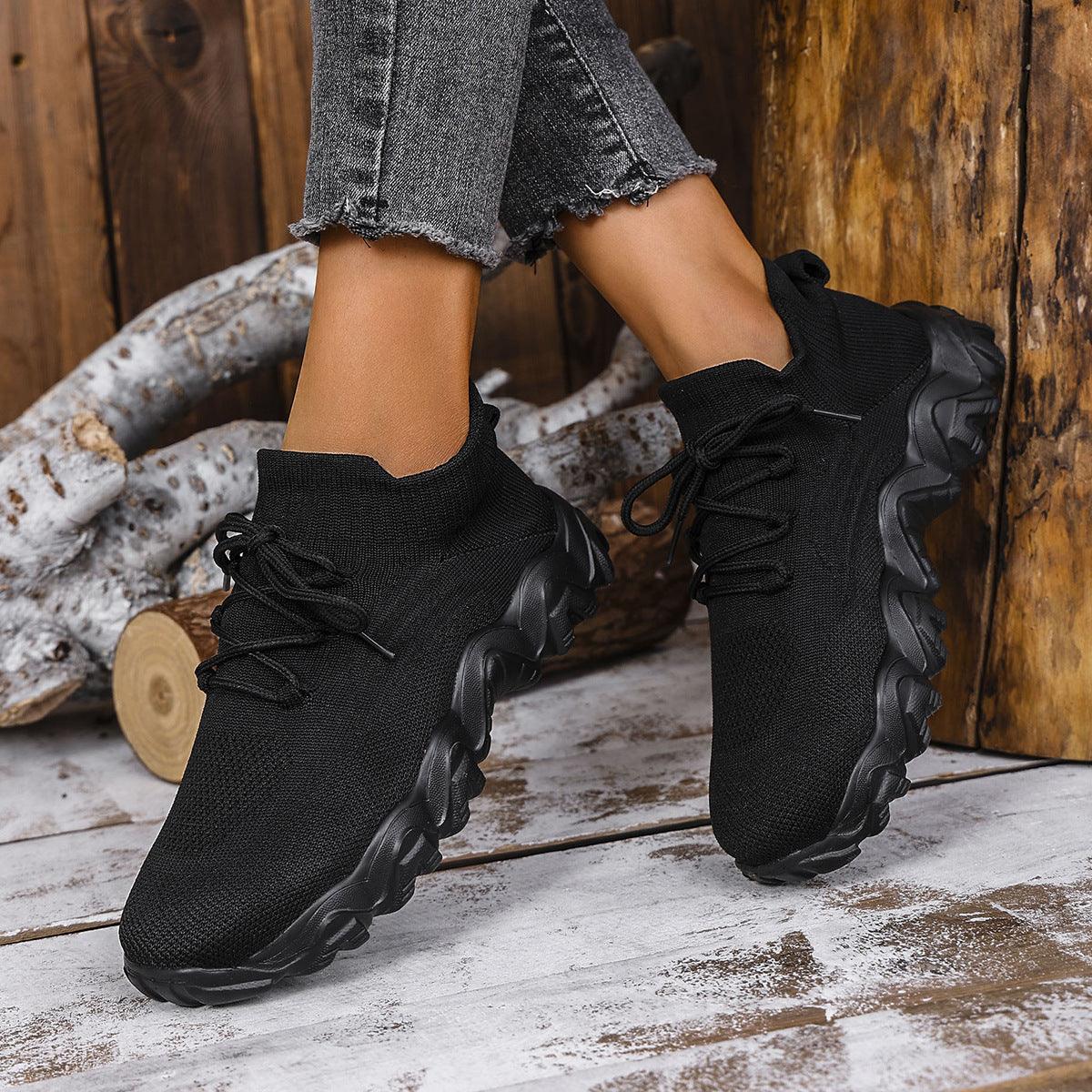 Women’s lace-up mesh sneakers, black knit upper and thick sole with tread