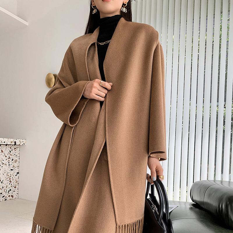 Camel long wool coat with hood and fringe hem, open front over dark inner layer