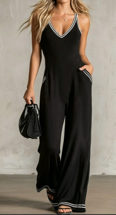 Black wide-leg jumpsuit with contrast V-neck trim and white piping at hems