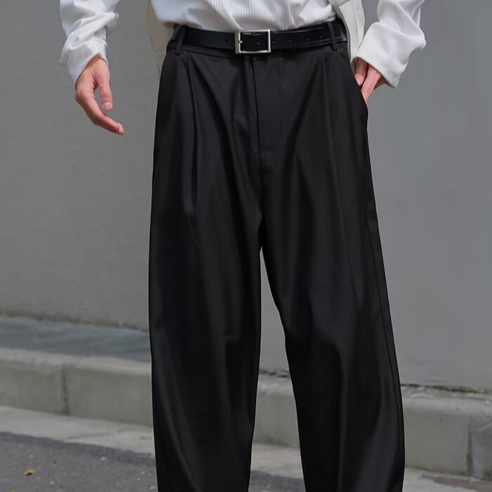 Black loose straight-leg casual pants with belt and pleated front detail.