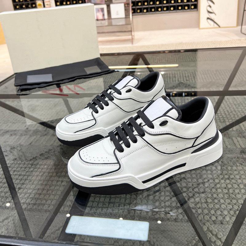 White lace-up leather sneakers with black laces and thick midsole