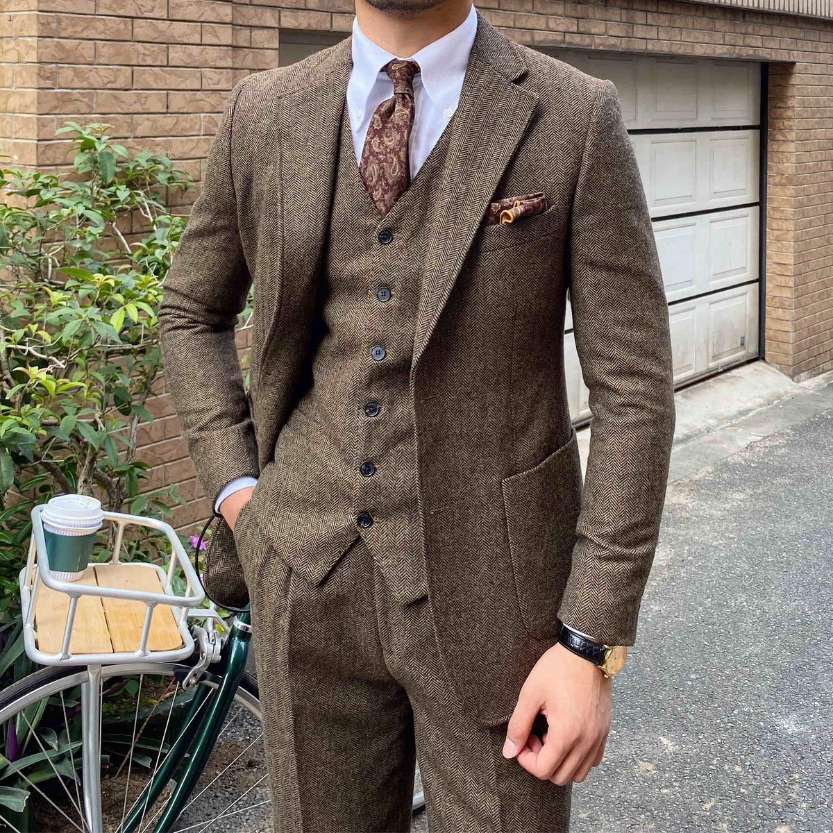 Men's slim-fit 3-piece suit in brown tweed, front view with vest buttons and tie