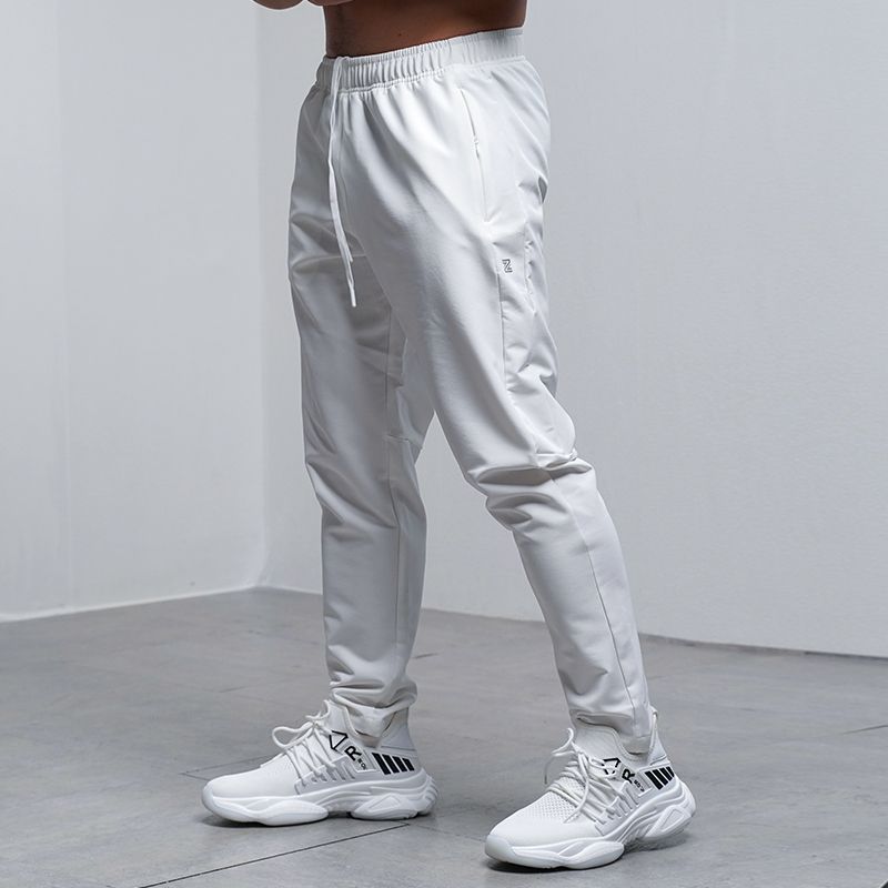 Men's white sweatpants with elastic waistband and drawstring, tapered ankle cuffs.