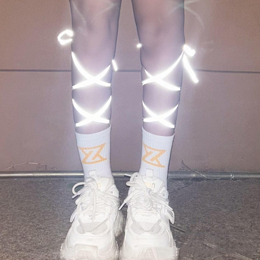 Reflective luminous dance socks with glowing star accents on white sneakers