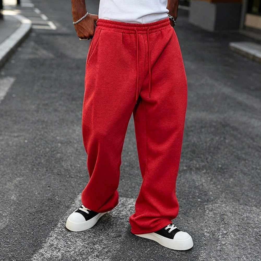 Red elastic-waist sweatpants with drawstring, relaxed straight-leg style and cuffs.