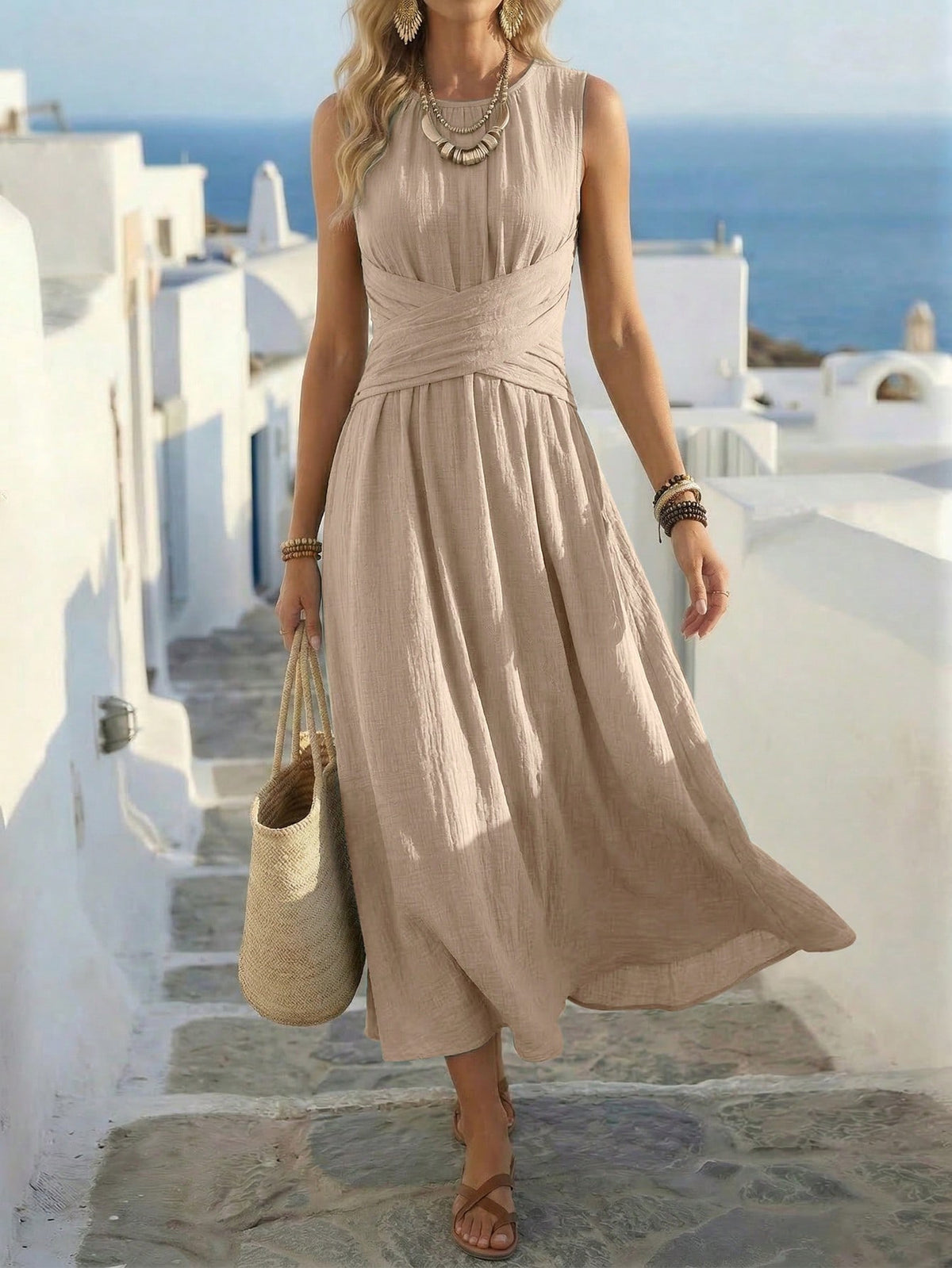 Apricot sleeveless maxi dress with gathered waist and flowy pleated skirt