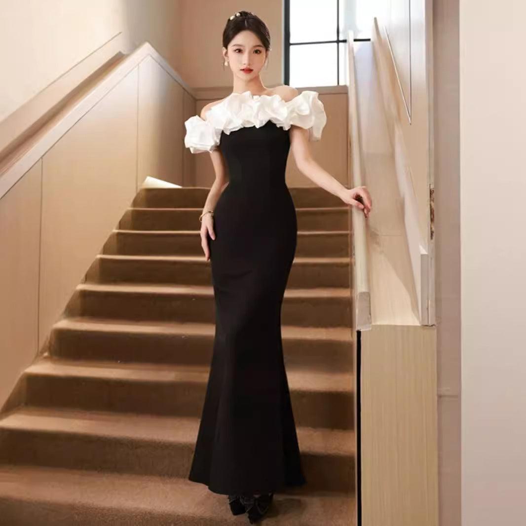 Black off-shoulder party dress with white ruffled neckline and fitted mermaid silhouette