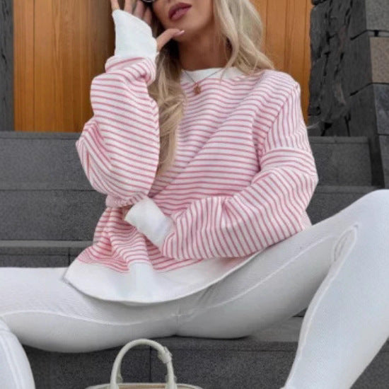 Pink and white striped round-neck sweater with long sleeves and ribbed cuffs