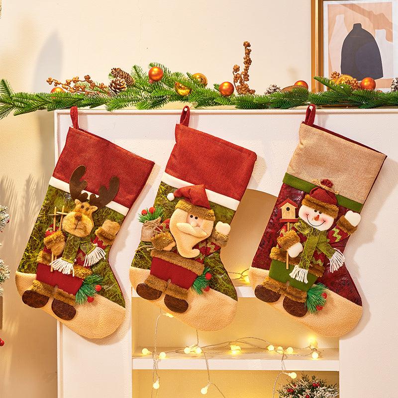 Set of three hanging Christmas stockings with cartoon characters on beige fabric