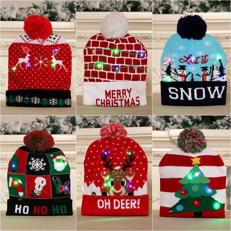 LED Christmas beanie with red knit and pom-pom; snowflake and tree graphics with glowing lights.