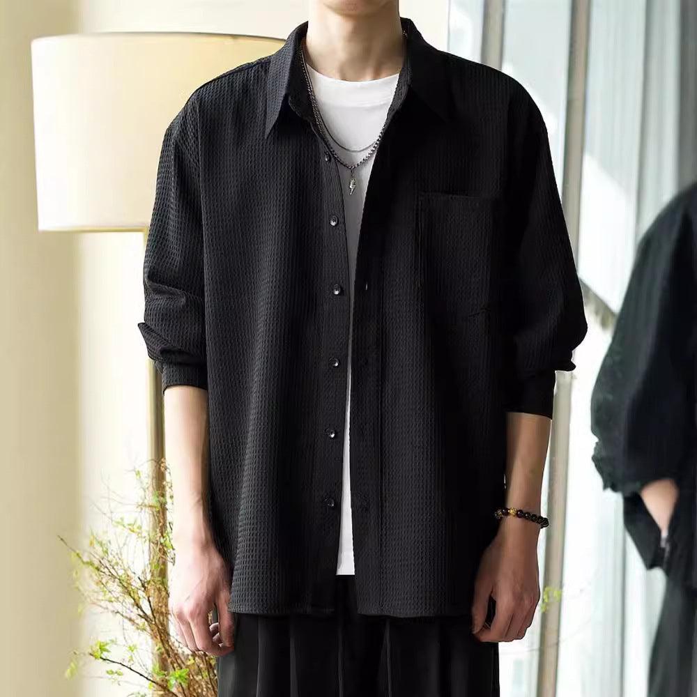 Black waffle polo-collar jacket with button front and chest pocket, relaxed fit