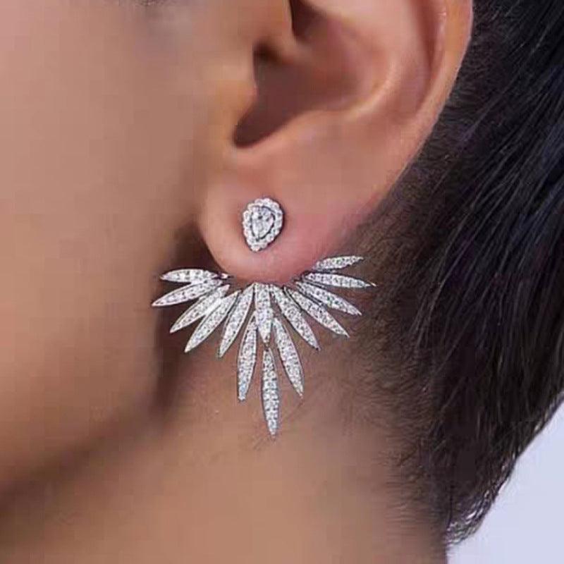 Silver angel wing earrings with small round stud accents and wing drop details
