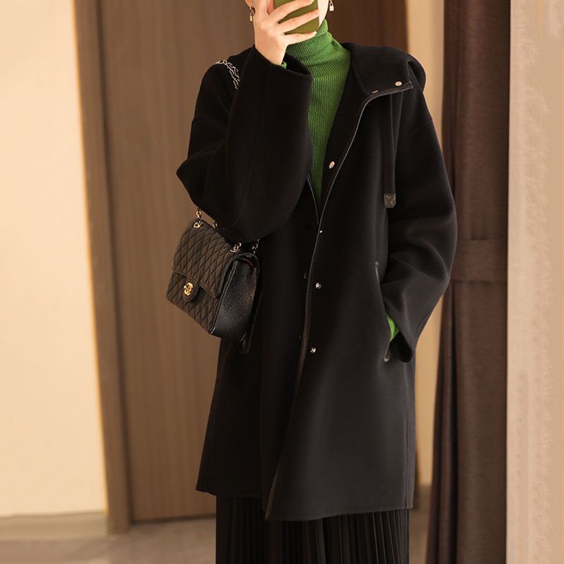 Black hooded wool coat with button front and long sleeves.