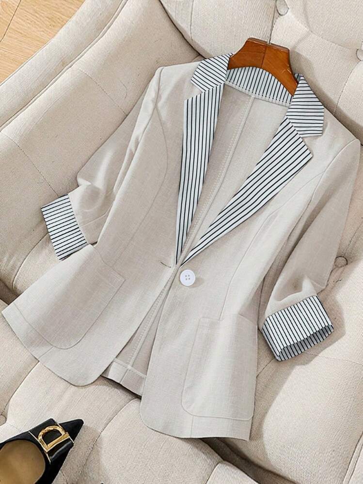 Women’s loose blazer top in light champagne with striped collar, cuffs, and button front
