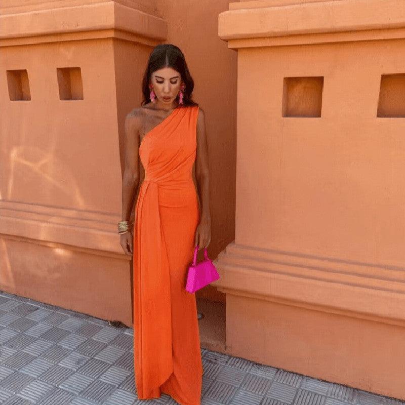 Orange one-shoulder knitted maxi dress with draped side.