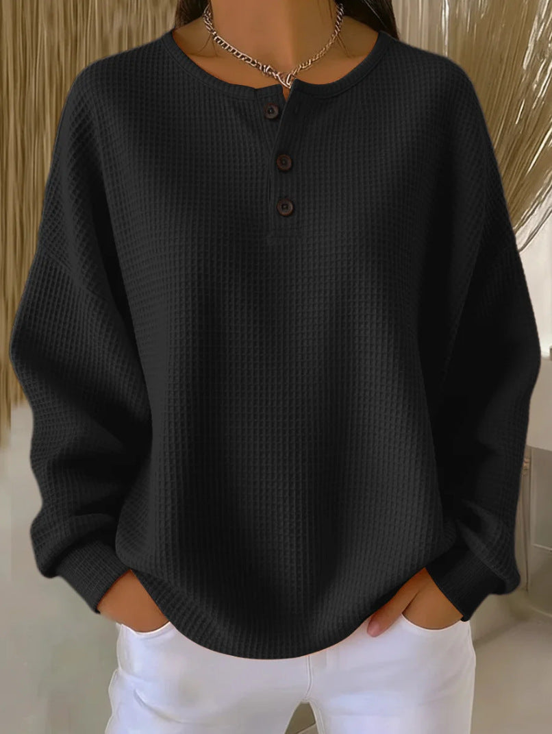 Black waffle knit long-sleeve henley pullover with round neck and 3-button placket