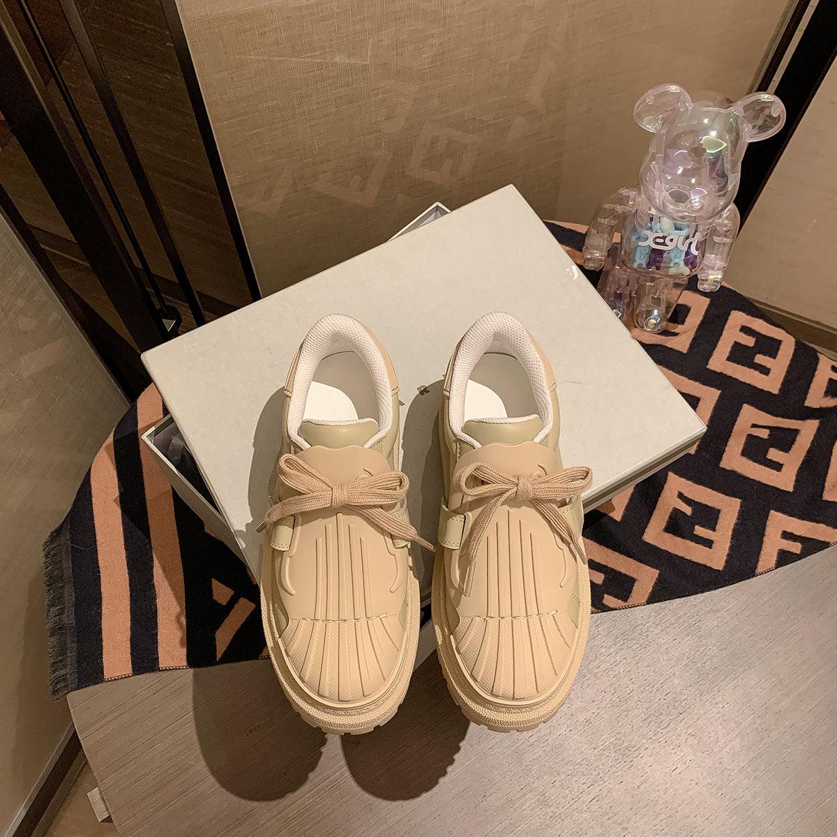 Women’s apricot shell-toe platform sneakers on a box, lace-up bow detail