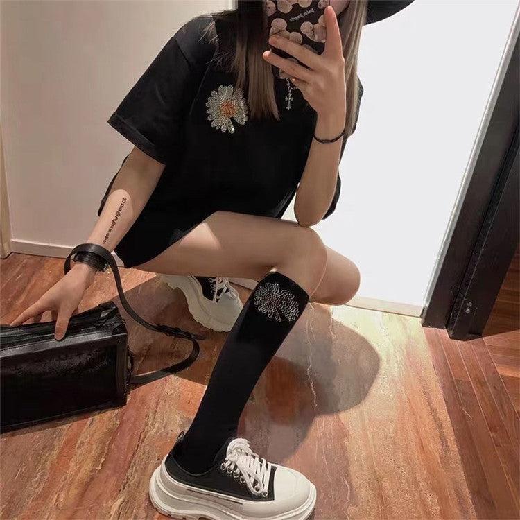 Thick-soled canvas sneakers in black with white lace-up front