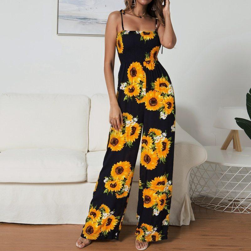 Sling jumpsuit with black background and scattered yellow sunflower print, wide-leg style