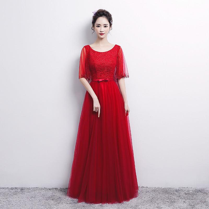 Red evening dress with sparkling bodice, short sheer sleeves, and layered tulle skirt