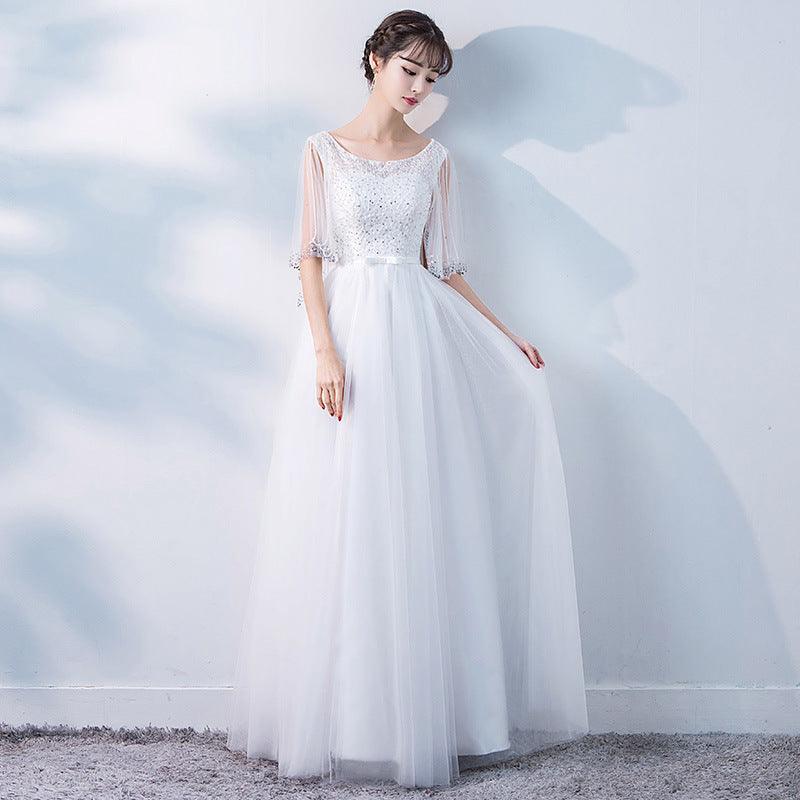 White evening dress with lace bodice, short mesh sleeves, and flowing tulle skirt