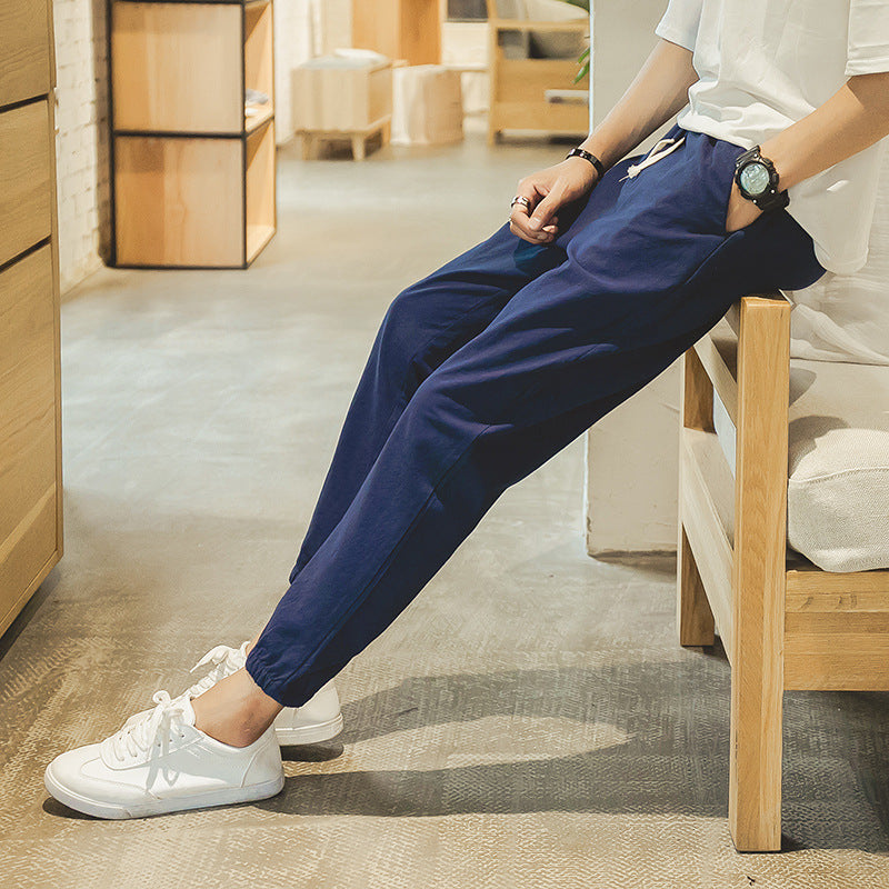 Navy blue cropped jogger pants with elastic cuffs and drawstring waist