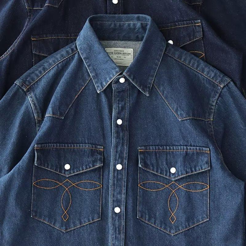 Dark blue boys denim button-up shirt with pointed collar, two chest pockets, white buttons