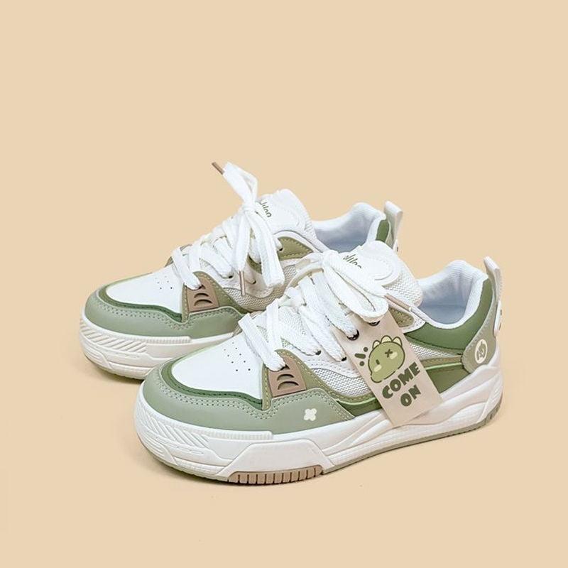 Green platform dad sneakers with white laces and thick sole, playful patches.
