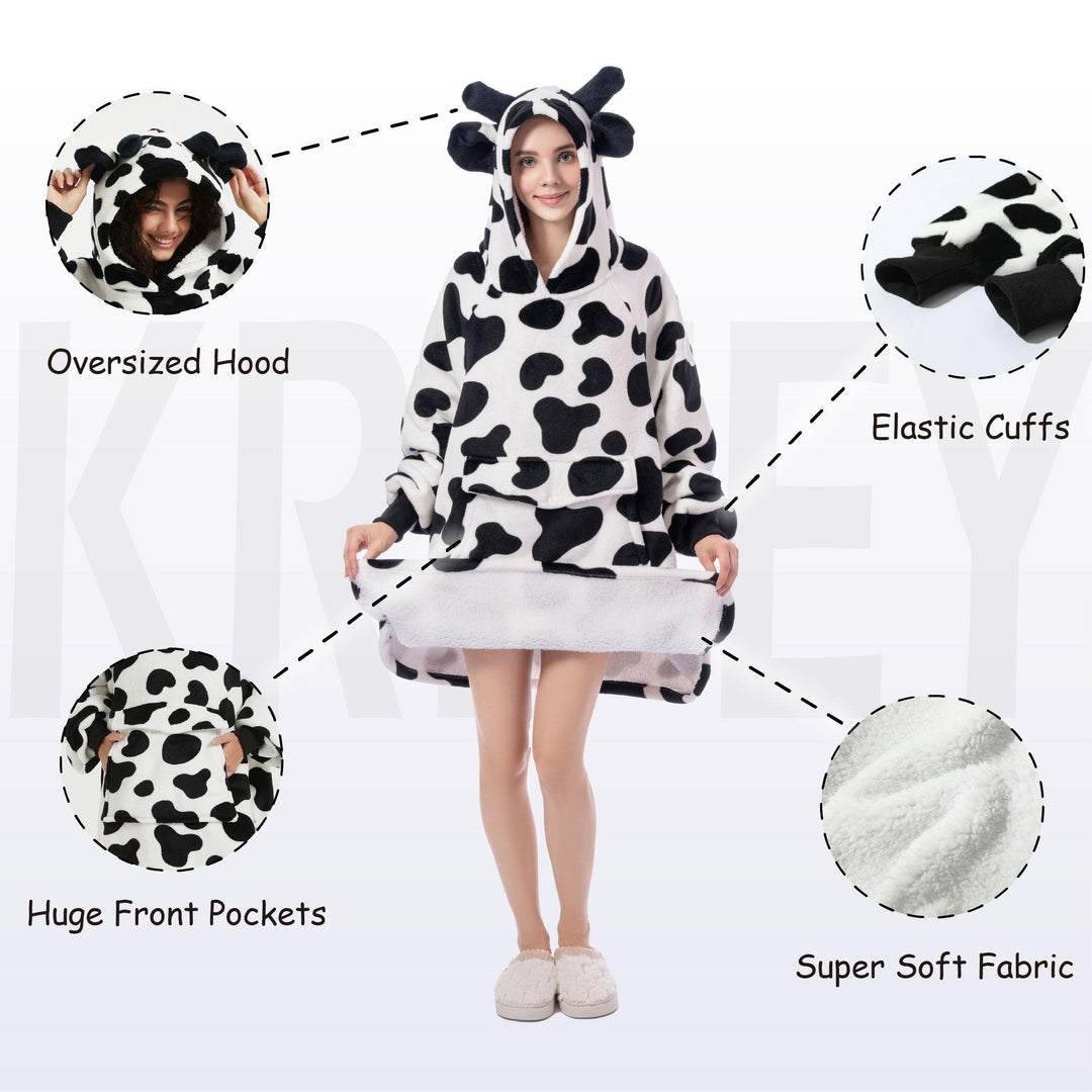 Black-and-white cow print wearable blanket hoodie, oversized hood, front pocket, elastic cuffs