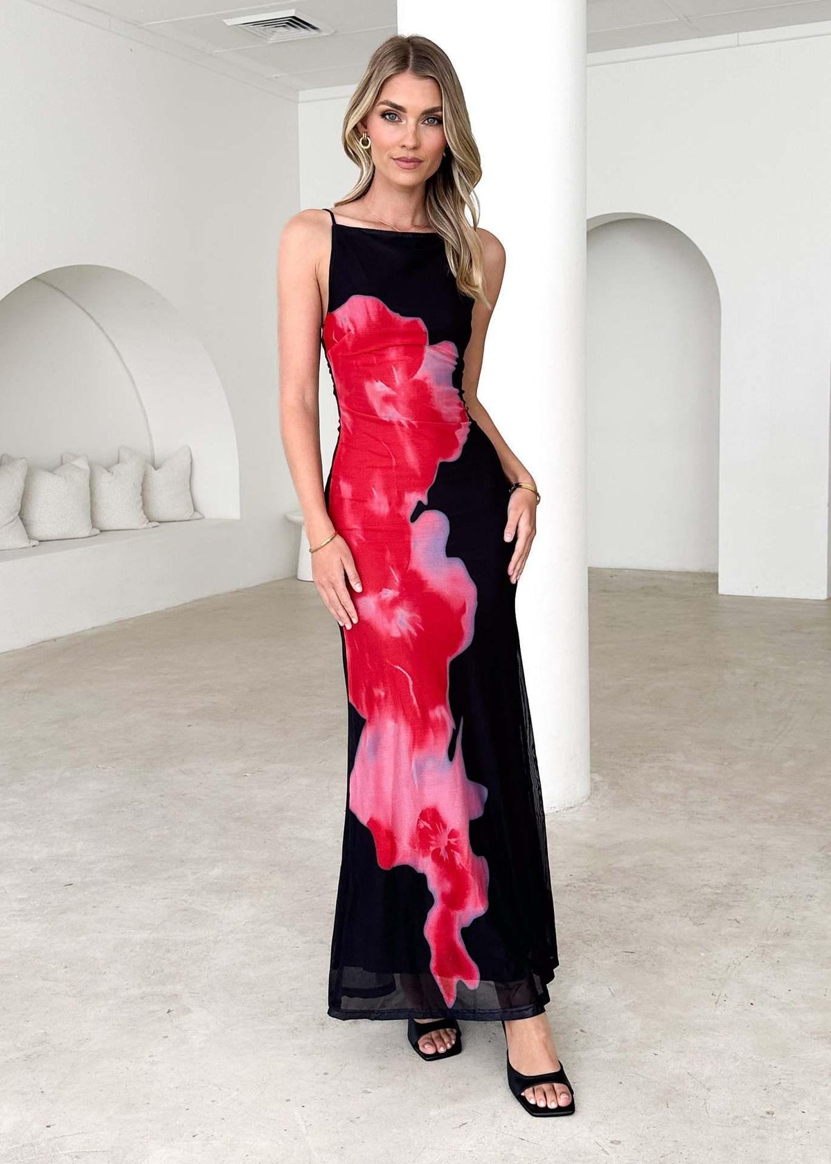 Black sleeveless maxi dress with red-pink floral print and contrast side panels