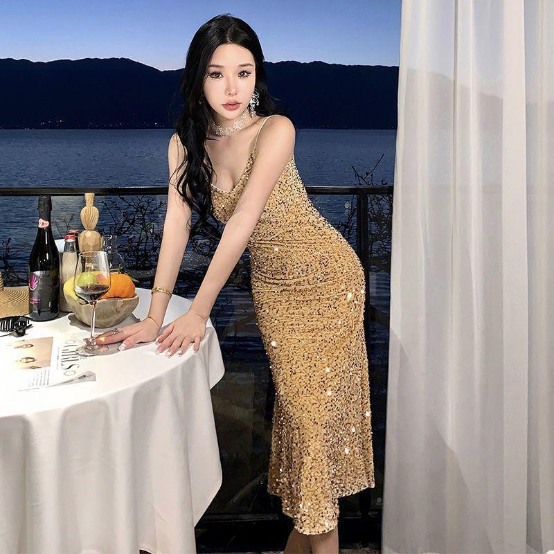 Gold sequin spaghetti-strap slip dress with a scoop neckline, midi length.