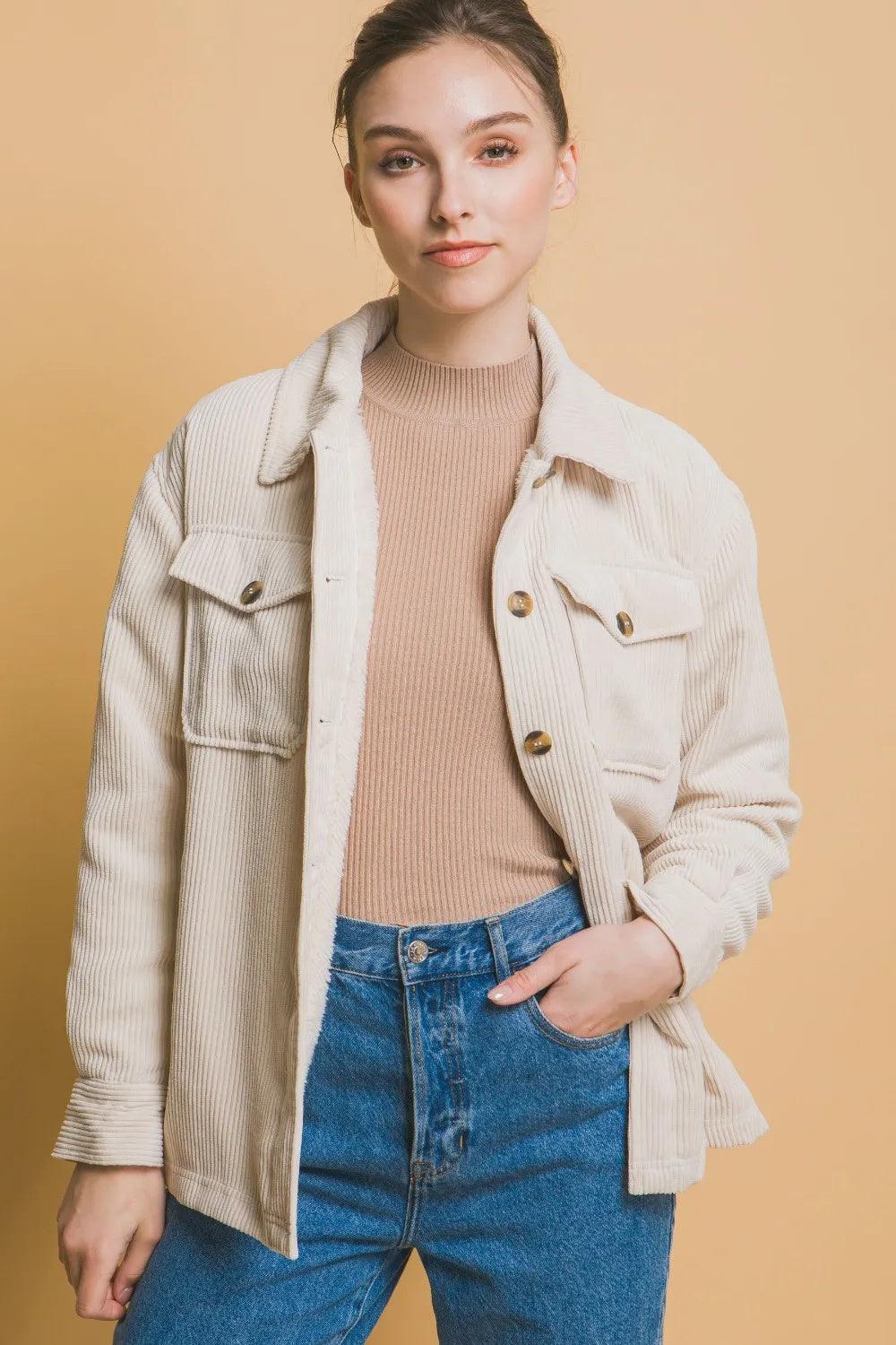 Cream corduroy button-up jacket with chest pockets and gold-tone buttons