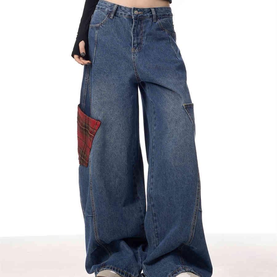 Blue wide-leg patchwork jeans with red plaid side panels and long relaxed fit