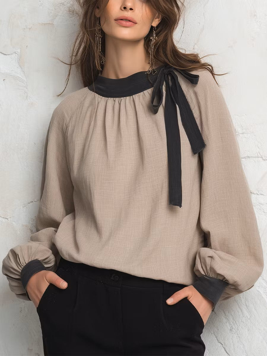Women's taupe long-sleeve blouse top with black ribbon bow at collar