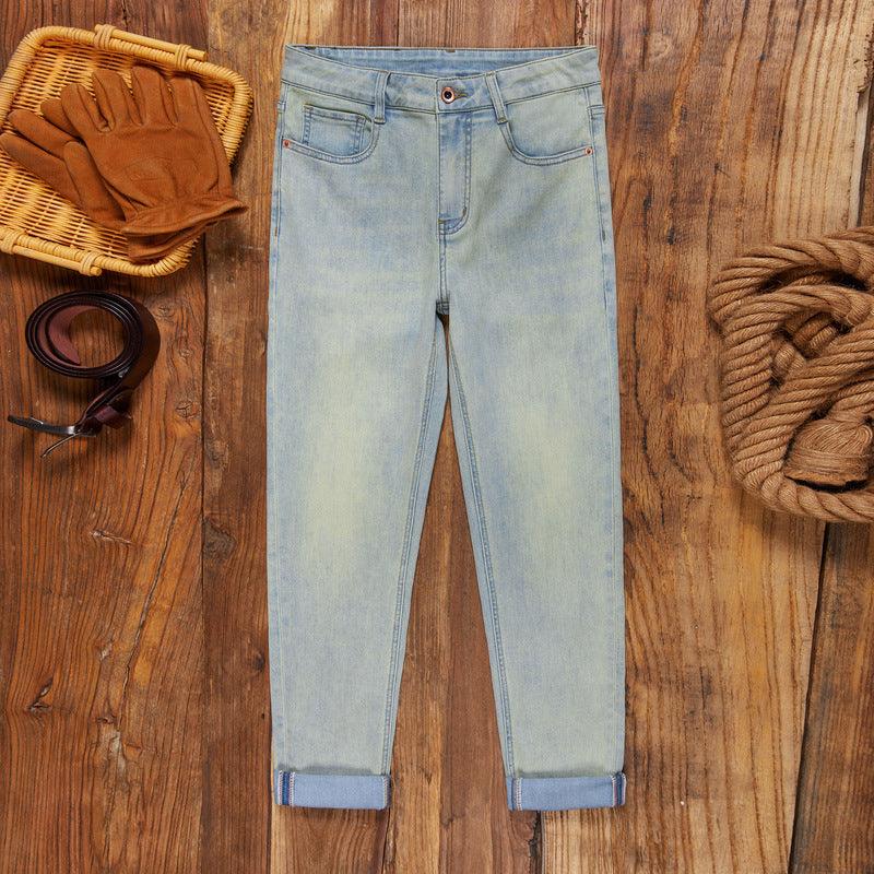 Light blue men’s stretch jeans with cuffed, ankle-tied hems and classic five-pocket design