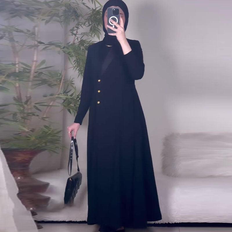 Long black single-breasted trench coat with gold buttons and long sleeves