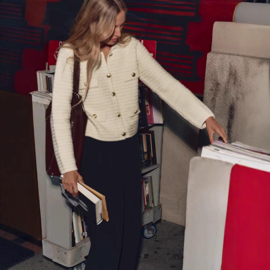 Milky white knitted cardigan jacket with notch lapels, button front, and chest pockets
