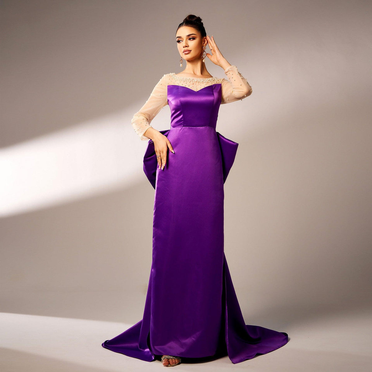Purple satin evening dress with beaded lace neckline, long lace sleeves, and side bow