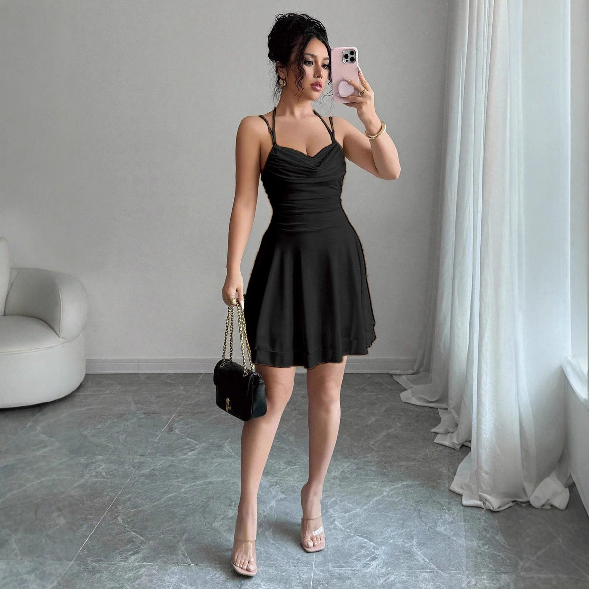 Black waist-cinching slip dress with flared skirt and spaghetti straps