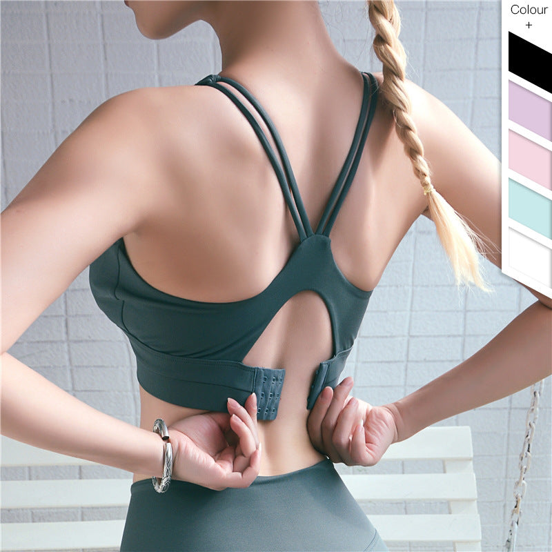 Dark green adjustable-back sports bra with crossover straps and back keyhole cutout