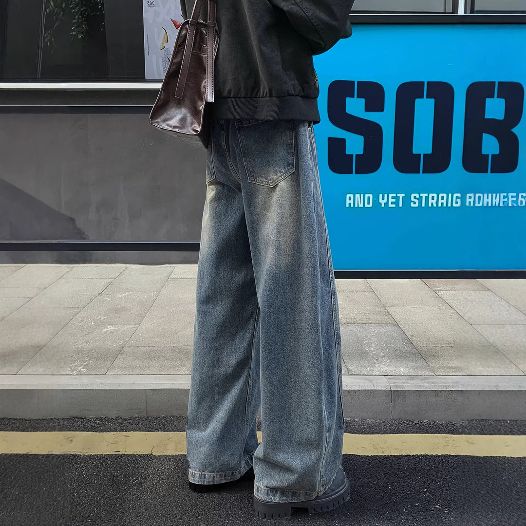 Men's light blue bootcut jeans with front button, belt loops, and side pockets
