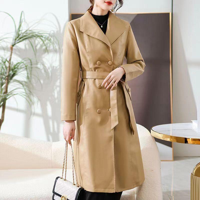 Women's tan windbreaker coat with notched lapels, button front, and waist tie belt