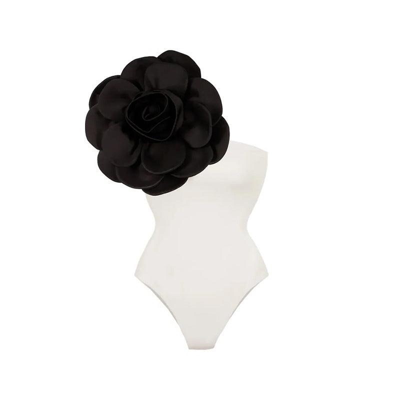 White one-piece swimsuit with black rose applique at the back of the neck