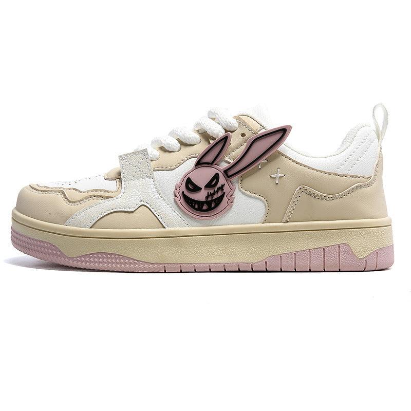 Beige and white low-top sneaker with cartoon bunny face patch and lace-up