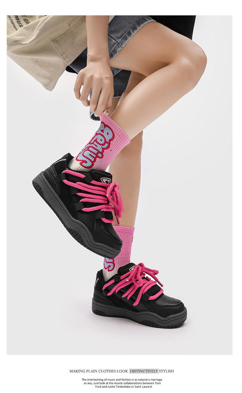 Black retro sports shoes with hot pink laces and pink logo socks