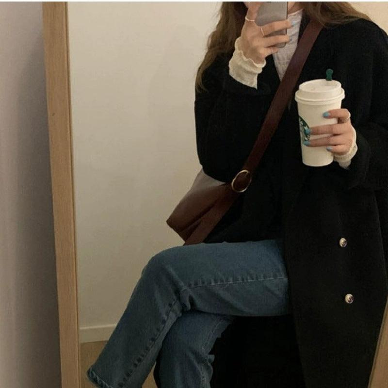 Women’s mid-length black double-breasted wool trench coat with dark buttons