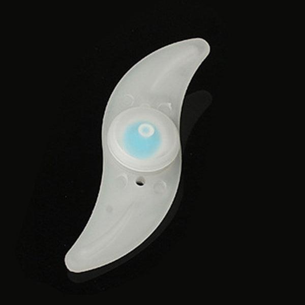 White crescent-shaped LED night light with a blue glowing eye lens